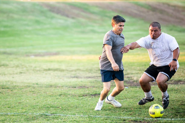 istock Mixed Age Group of Latino Men Playing Soccer 1046308906