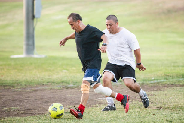 istock Mixed Age Group of Latino Men Playing Soccer 1046308908