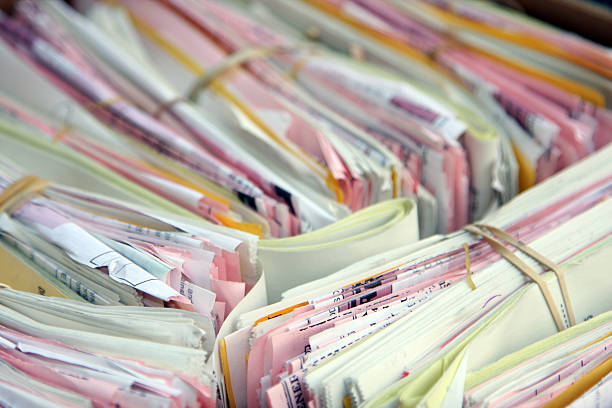 Stack of pink and white documents tied with elastic rubber stock photo