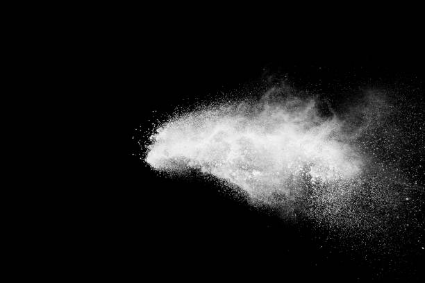 istock White talcum powder explosion splashing on black background. Use for web design or billboards abtract background. 1046321752