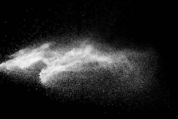 istock White talcum powder explosion splashing on black background. Use for web design or billboards abtract background. 1046321786