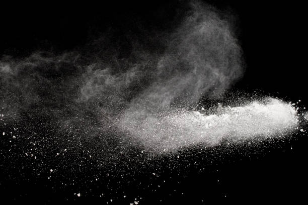 istock White talcum powder explosion splashing on black background. Use for web design or billboards abtract background. 1046321826