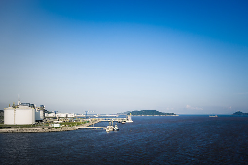 Liquefied natural gas storage tanks by the sea