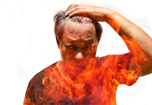 Double exposure of Asian men and flame, Fire erupts in the body of an angry man isolated on white background, Stress in the mind affects the body, Psycho savage human, Insanity face and fierce eye