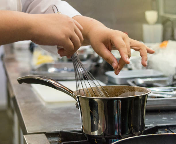 istock Chef preparing food, meal, in the kitchen, chef cooking, Chef decorating dish, closeup, chef at work 1046333652