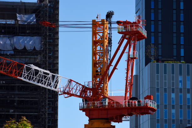 istock Crane of large construction site against clear sky. 1046335364
