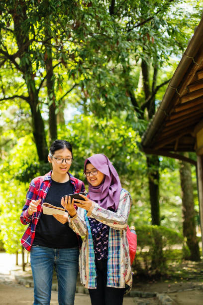 istock Two young women using a smart phone to navigate their vacation in Japan 1046340850