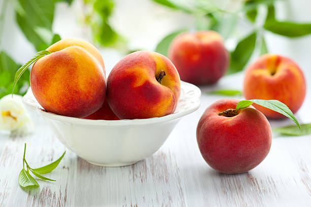 Peaches in bowl and on the table