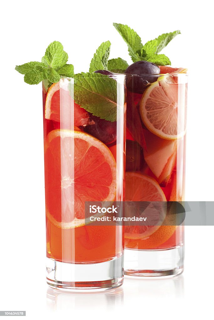 Two glasses filled with refreshing fruit sangria Cocktail collection: Refreshing fruit sangria (punch) isolated on white background Cut Out Stock Photo
