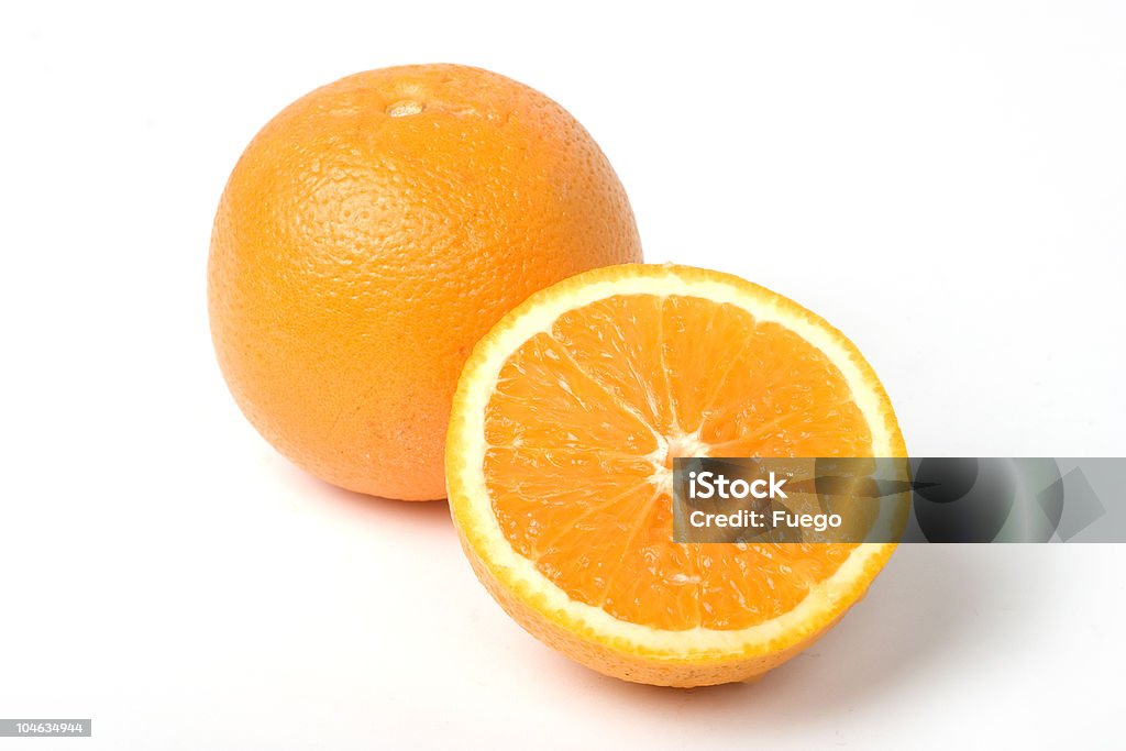 Two oranges, one intersected to half. With clipping path Two beautifull oranges. One on half, clipping path included Valencia Orange Stock Photo