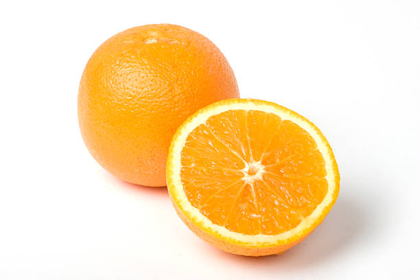 Two oranges, one intersected to half. With clipping path Two beautifull oranges. One on half, clipping path included valencia orange photos stock pictures, royalty-free photos & images