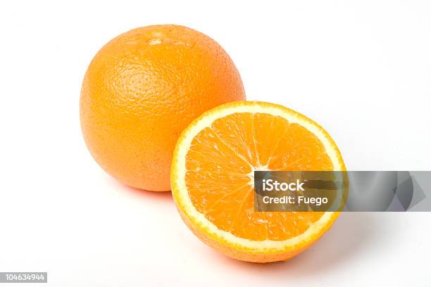 Two Oranges One Intersected To Half With Clipping Path Stock Photo - Download Image Now