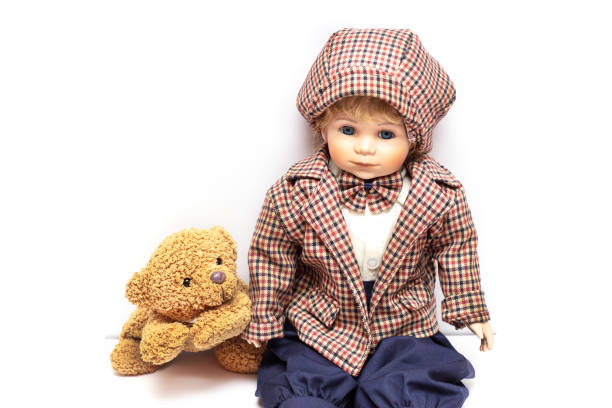 Old porcelain doll on White Background Antique porcelain doll on white background. Concept of time.