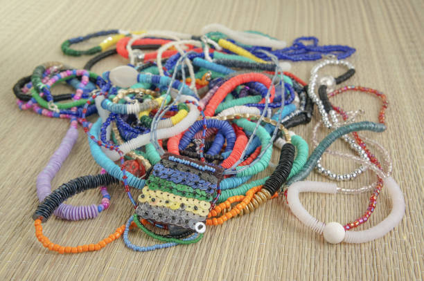 istock Colorful handmade necklaces on a woven cloth 1046355334