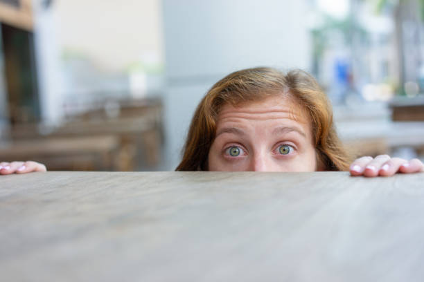 istock Excited red haired young woman playing hide and seek 1046355640