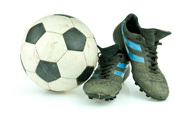 istock Soccer ball and vintage cleats 104636226