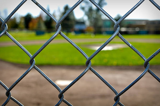 istock Baseball Diamond viewed through a Chain Link Fence 104636431