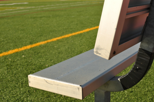 Empty Bench on the Sideline of a Football Field