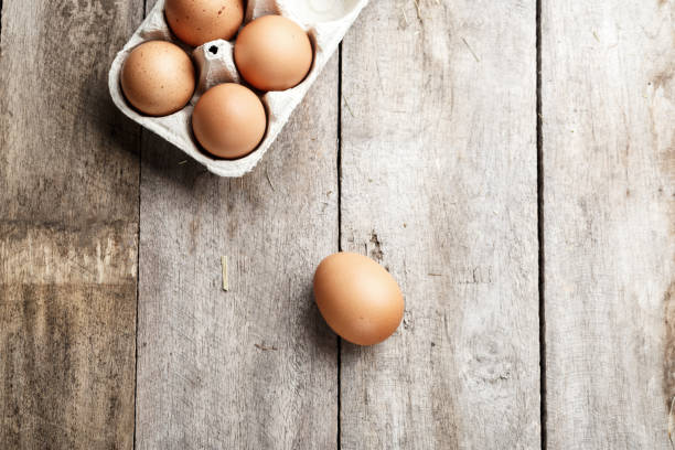 istock chicken eggs in a tray on a wooden background. 1046366310