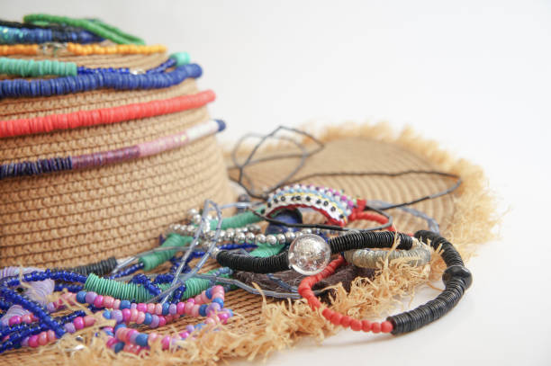 istock Colorful handmade necklaces on a straw hat 1046366402