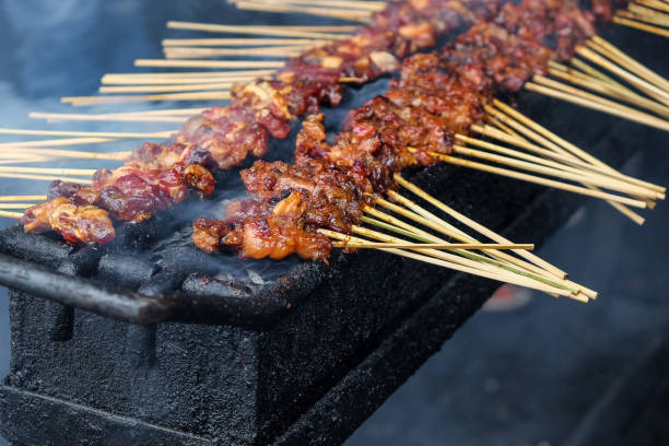 istock Chicken satay skewer on bbq coal grill 1046366454