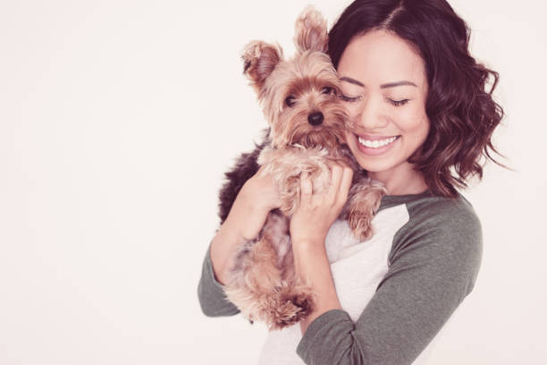 istock Happy Pretty Woman Embracing Yorkshire Terrier 1046366616