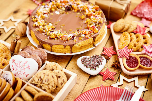 istock wooden table with delicious Christmas cake decorations and different cookies 1046369350