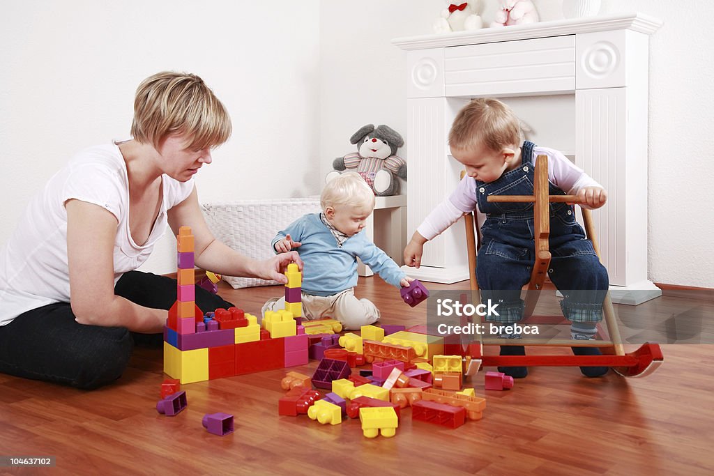 Playtime Kids in kindergarten with their teacher 12-17 Months Stock Photo