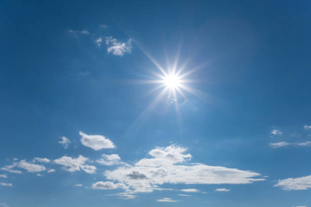 istock sparkle sun on the blue cloudy sky, nature background 1046391248
