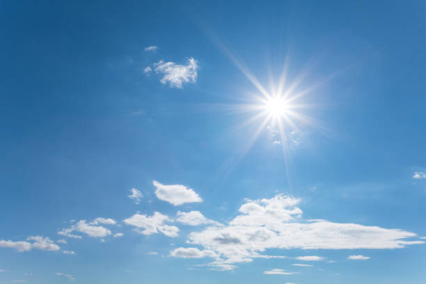 istock sparkle sun on the blue cloudy sky, nature background 1046391250