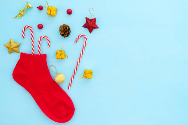 istock Red christmas stocking with decoration on blue background. 1046397564
