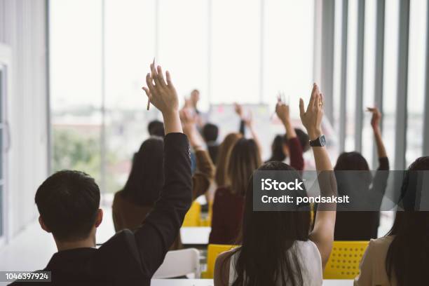 Asking In Seminar Class Room At Conference Stock Photo - Download Image Now - Hand Raised, Arms Raised, Classroom