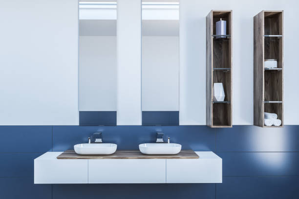 istock Double bathroom sink in white and blue room 1046398282