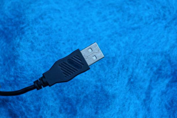 istock part of a black computer cord on a blue background 1046403830
