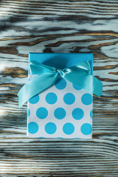istock Blue gift box on vintage wooden board 1046405924