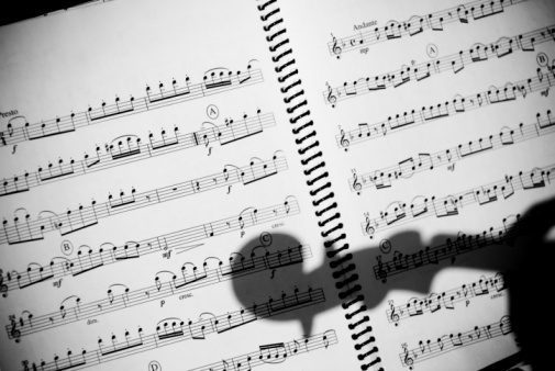 White paper with musical notes closeup background. Music writing concept