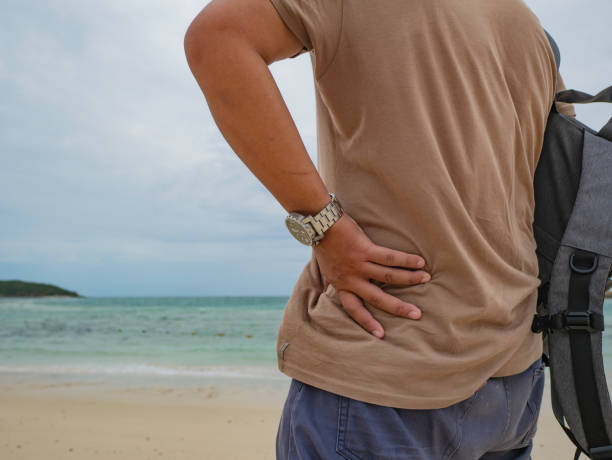 istock Asian fat backpacker stand while Use mobile phone  on the idyllic beach with beautiful Sky in vacation time 1046406768