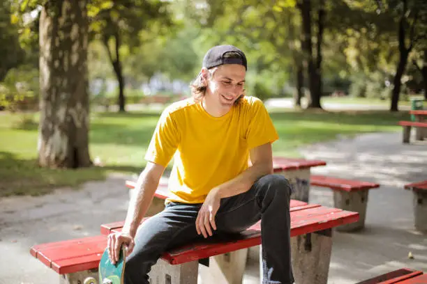 Young man hanging out in a park on the table