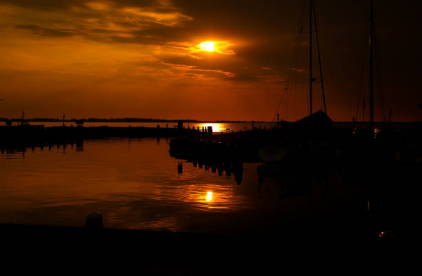 The boats at the sea harbour in the Dutch fisherman village Marken at the sunset.