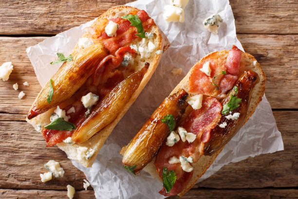 rustic bread with caramelized onion, cheese, bacon and herbs close-up. horizontal top view - onion caramel appetizer bread imagens e fotografias de stock