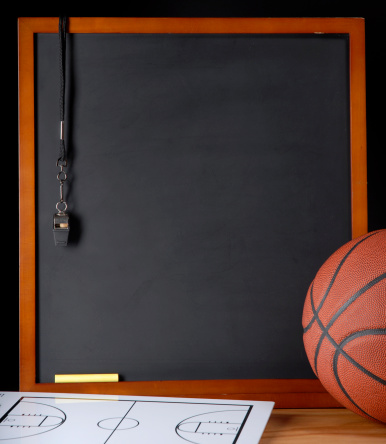 Stock photo of a black board with basketball and whistle