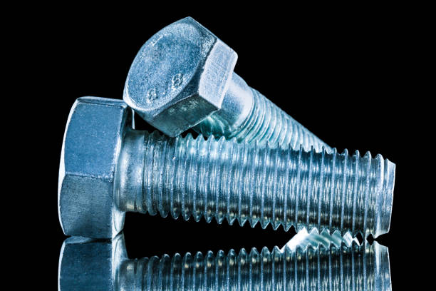 istock Stainless screwbolts on black surface 1046415672