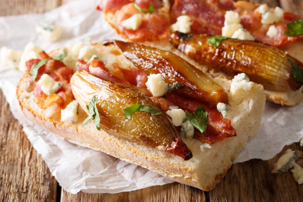 rustic bread with caramelized onion, cheese, bacon and herbs close-up. horizontal - onion caramel appetizer bread imagens e fotografias de stock
