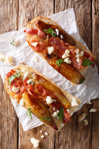 rustic bread with caramelized onion, cheese, bacon and herbs close-up. vertical top view - onion caramel appetizer bread imagens e fotografias de stock