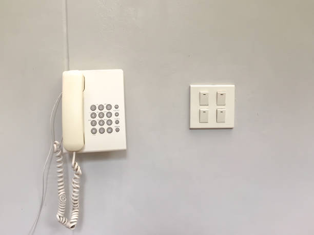 istock white telephone and light switch pad on the white wall 1046419582