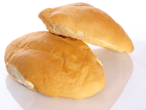 Sliced loaf of white sourdough bread on light background