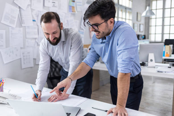 istock Businessman and male assistant in modern office 1046422276