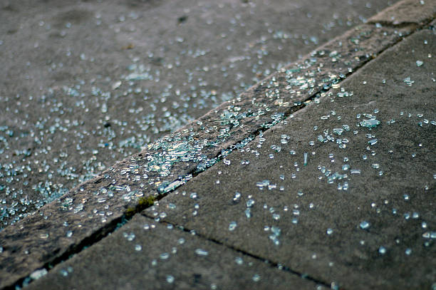 Broken windshield glass on sidewalk stock photo