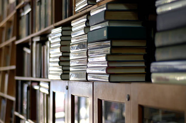 istock Bookshelves piled with books 104642478