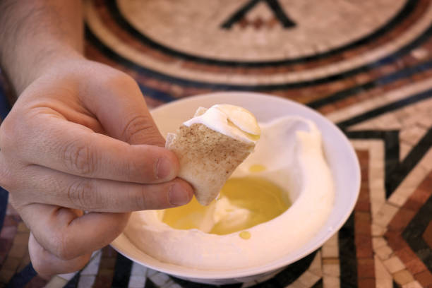 istock Dipping Pita Bread in Labneh 1046431686